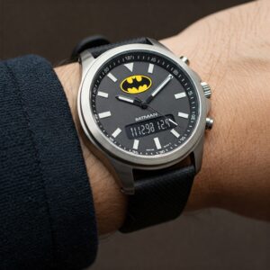 A person wearing a Batman watch on their wrist, showcasing its style and functionality.