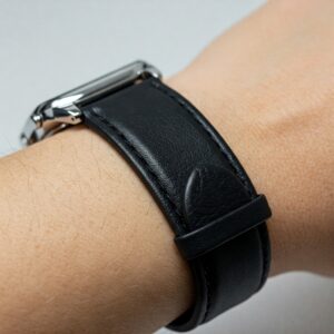 A black leather watch strap comfortably fitted on a wrist.