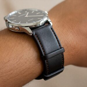 "Elegant brown leather watch strap on a person's wrist."