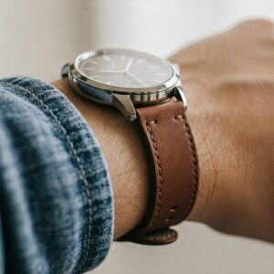 A wristwatch with a stylish 16mm watch strap on a person's wrist.