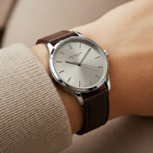 A woman's wrist wearing a stylish coach watch with a comfortable leather strap.