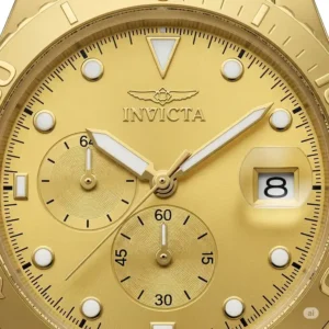 Close-up view of an Invicta watches gold dial, highlighting the intricate details, luminous hands, and date display.
