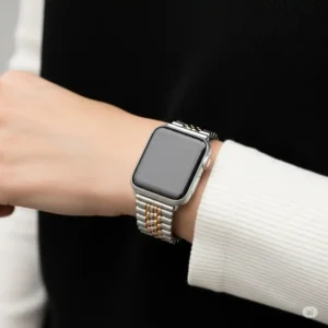 Person wearing an Apple Watch with chic apple watch straps silver and gold on their wrist, demonstrating comfort and style.