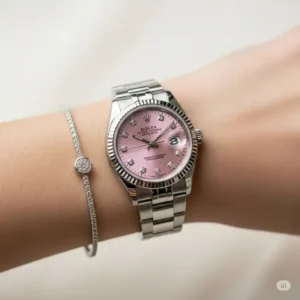 Elegant women's pink faced Rolex watch on a wrist, highlighting its feminine appeal.