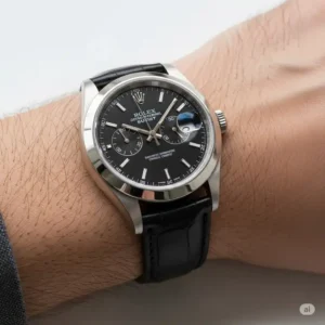 Stylish shot of a Rolex timepiece comfortably worn on a wrist, featuring a premium black leather watch band, perfect for a sophisticated look.