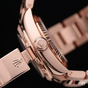 Macro shot highlighting the iconic crown and secure clasp of a genuine pink Rolex watch.