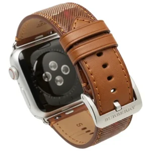 An elegant user wearing an Apple Watch Burberry strap in a classic Trench color.
