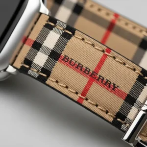 A stylish shot of a woman's wrist showcasing a chic Apple Watch Burberry strap.