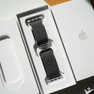 An unboxing image showing the new double-strap Apple Watch band neatly packaged in its box, ready to be attached. 