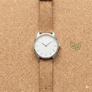 An eco-friendly timepiece with a cork strap on a natural background, showcasing the best watches for minimalist fashion style for sustainable lovers.