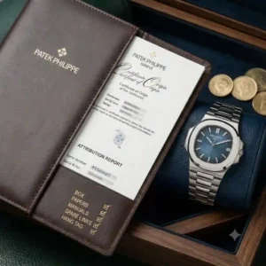 A Patek Philippe luxury watch displayed alongside its original certificate of authenticity and leather box to maximize long-term resale value as one of the top investment watches for 2026.
